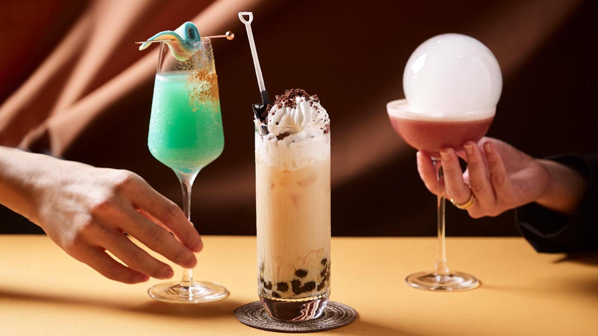 Crowne Plaza Changi Airport By Ihg Singapore Exterior photo The photo features three colorful and creatively presented cocktails. 

1. On the left, there is a bright green drink served in a tall glass, garnished with a playful decoration, likely a piece of candy or fruit.
  
2. In the center, a tall glass con